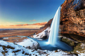 The beautiful Seljalandsfoss in Iceland during winter - obrazy, fototapety, plakaty