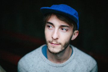 Portrait of a young man in a blue hat