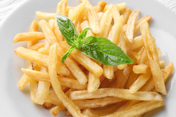 Plate with yummy french fries, closeup