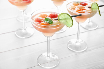 Glasses of delicious cocktails with melon balls on table