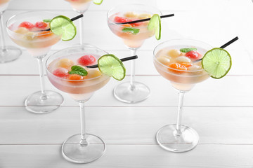 Glasses of delicious cocktails with melon balls on table