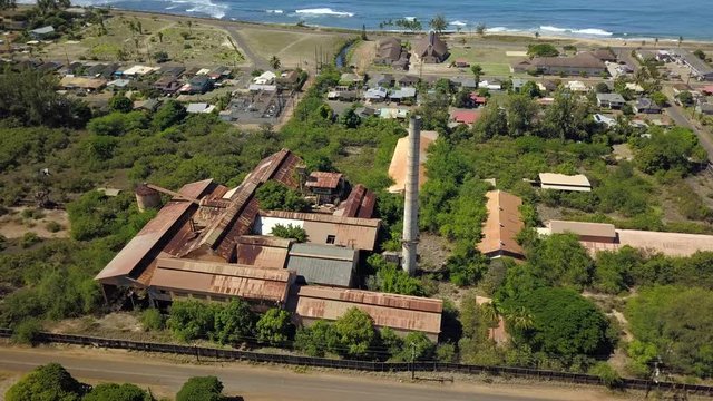 Aerial Waimea Kekaha Kauai Hawaii abandoned sugar mill circle. Old derelict Sugar Mill built 1835. Rusty building and equipment. Garden Isle. Economy is now tourism based.