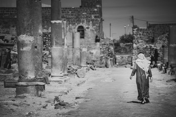 Bedouin walks in the streets of Bosra.