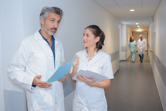 male doctor and female nurse in hospital corridor