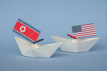 paper ship with Flags of USA and North Korea. conflict in Japanese sea, concept shipment or free...