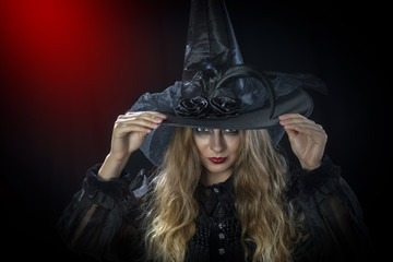 Beautiful woman in hat and leather gloves. Retro fashion model girl.black hat with large fields.Halloween witch