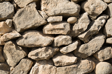 Stacked stones forming a wall.