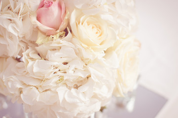 Close up on wedding flowers, bridal bouquet. Decoration made of roses over light celebration background