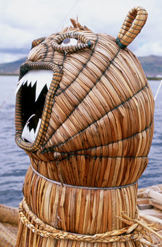 Animal head in front of a reed boat