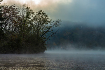 Mist over lake in sunny colorful morning