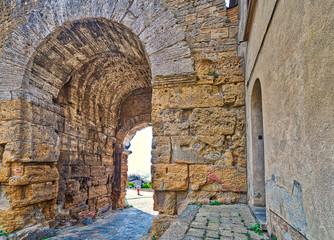 stone arch in street of Volterra