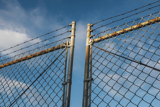 Detail of barbed wire and chain-link fence