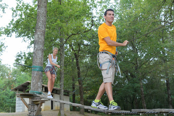 couple crossing the suspended bridge