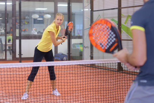 portrait of a couple playing paddle tennis