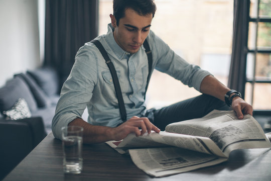 Young Man Reading Morning Newspaper