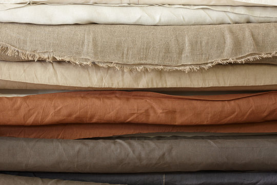 Exposed rolls of different fabric and colour in a textile workshop
