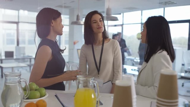  Female managers at a business seminar, talking & sharing ideas