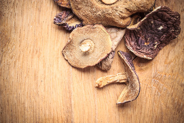 Dry mushrooms on wooden rustic table.