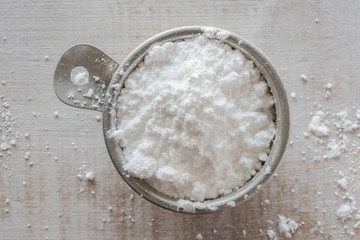 Powdered Sugar in a Measuring Cup