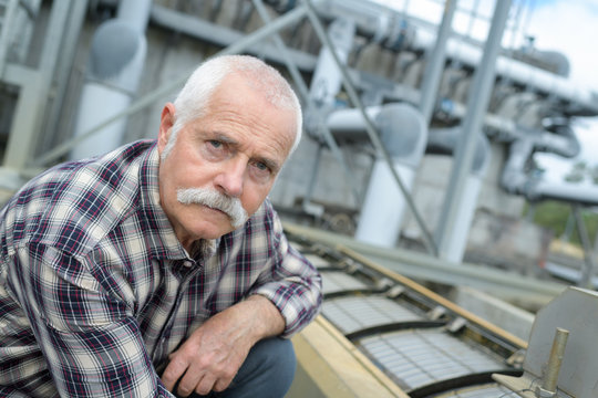 Senior worker on industrial plant