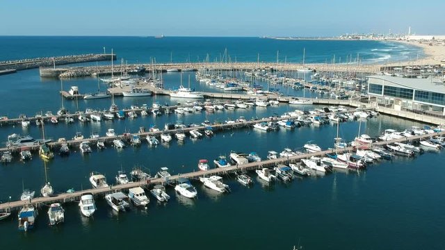 Tilt Reveal shot of boats docking at the Ashdod Marina
