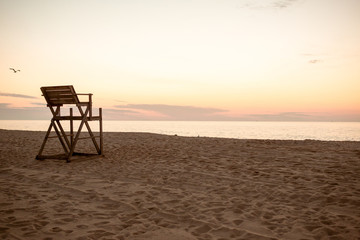 Fototapeta na wymiar lifeguard chair sunrise beach