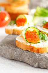 Sandwich with ricotta, a cucumber, caviar .