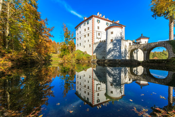 The picturesque 13th-century Sneznik Castle (Grad Snežnik, Schloß Schneeberg) reflecting in the pond, located in Loška Dolina, Slovenia © erikzunec