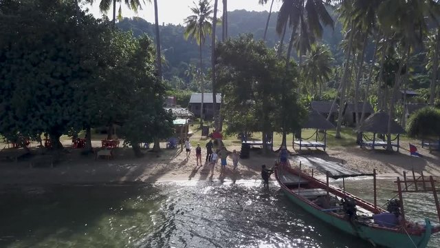 Backpacker tourists board a fisherman&rsquo;s boat as they prepare to be ferried back to the mainland, Kep, Cambodia from Koh Tonsay, Rabbit Island.