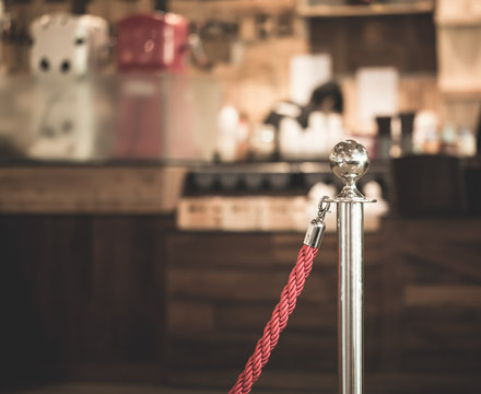 Stainless steel pole with red rope.