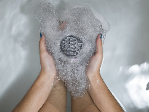 Hands holding a bath bomb