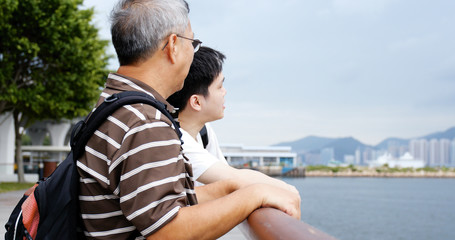 Fototapeta premium Father and son talking at sea side