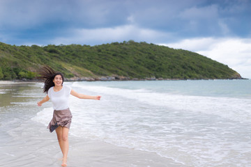 Fototapeta na wymiar Beautiful Asian woman vacation on beach of Thailand