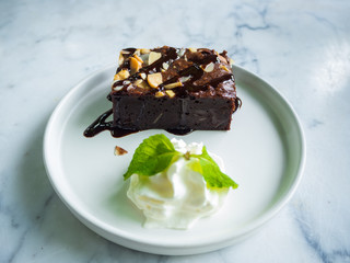 Sliced brownies on white plate on the white table