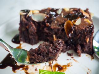 Sliced brownies on white plate on the white table