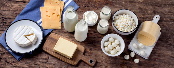 Dairy products on wooden background.