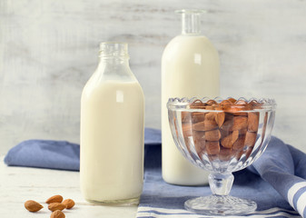 Almond milk in bottle with almonds