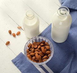 Almond milk in bottle with almonds
