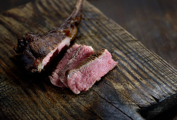 grilled lamb steak  on a wooden background.