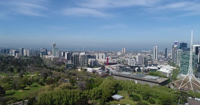 CBD towers and high-rise houses in Melbourne city CBD rotating from parks to train stations
