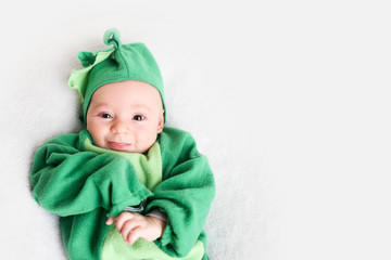 Baby dressed up in a dinosaur costume for Halloween