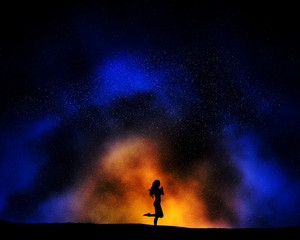Fototapeta na wymiar Female in yoga pose against a night sky background with nebula