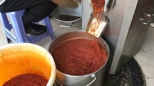 worker is making chilli sauce