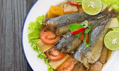 Mackerel boiled sweet and salted on white dish Thai food on old wooden table