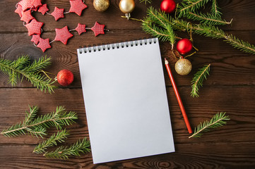 Empty white page of spiral notebook and christmas decoration on a wooden background. Flat lay. - 177499707