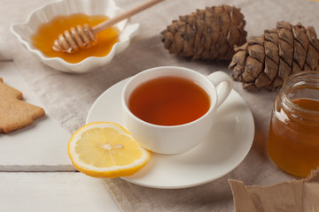 Tea with lemon and honey, homemade cookies and cones. Sweet tea party in autumn or winter morning