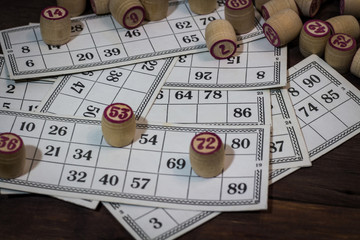 Vintage lotto on a wooden background. Cards and kegs