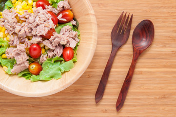 Tuna salad in bowl on wooden table.