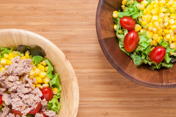 Tuna salad and Corn salad on wooden table.