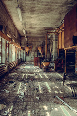 Destroyed and abandoned factory shop, complete mess and desolation. Remains of equipment and interior. © autau
